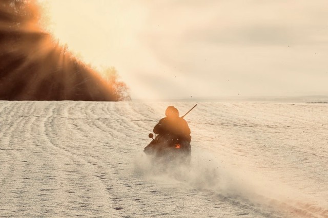 hunters by snowmobile in snowy field